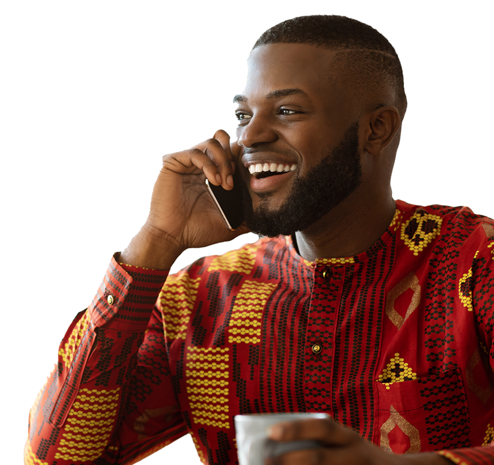 man smiling on the phone with a coffee in his hand