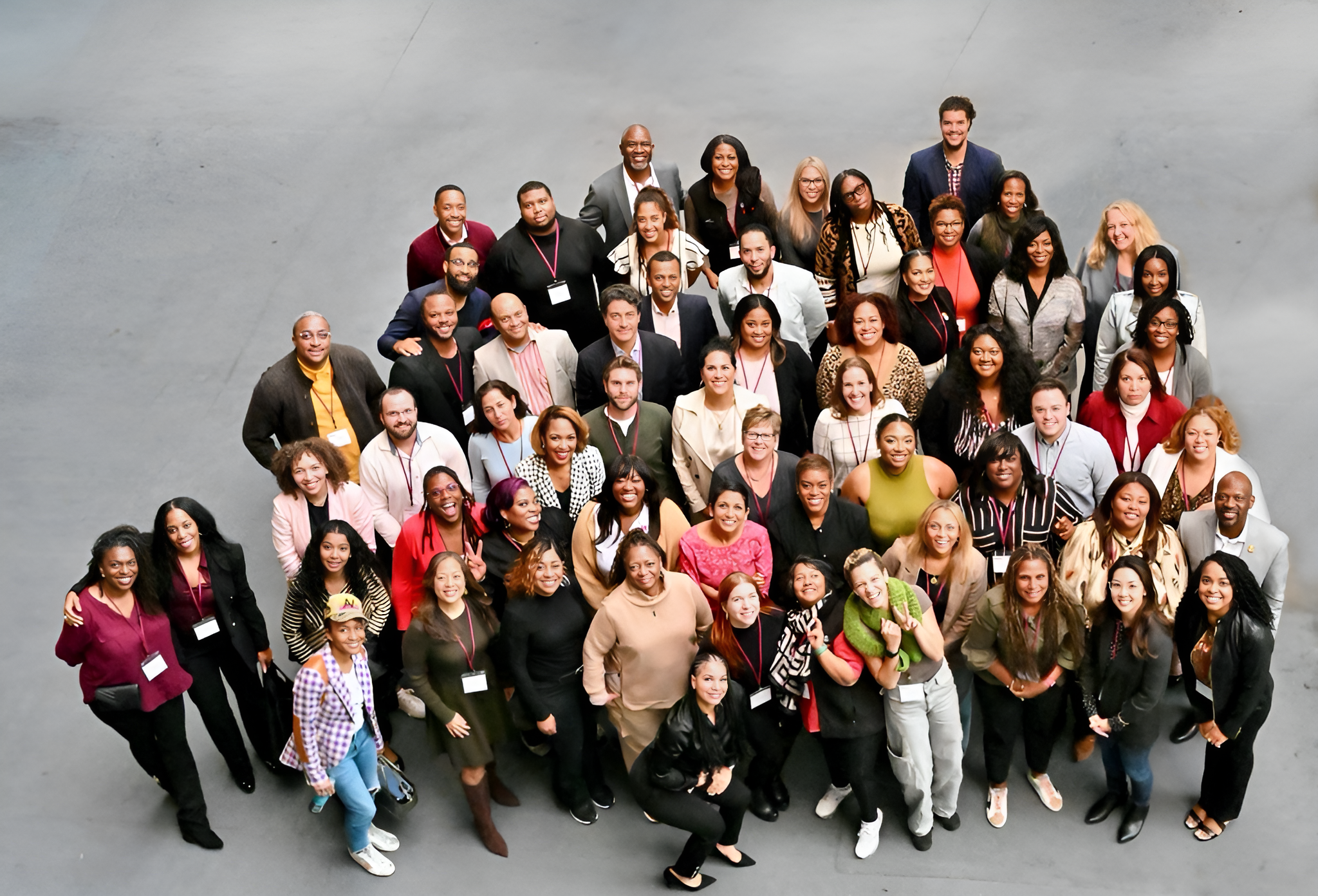 oneten team huddled together for an areal shot photograph of everyone